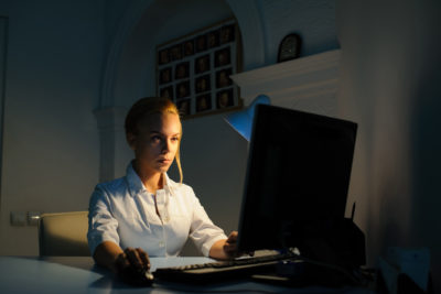 beautiful young woman doctor working at night in the office