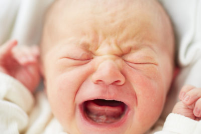 Newborn baby is crying - selective focus